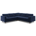 Full front view of the navy velvet corner sectional with tufted bench seat and bolster pillows