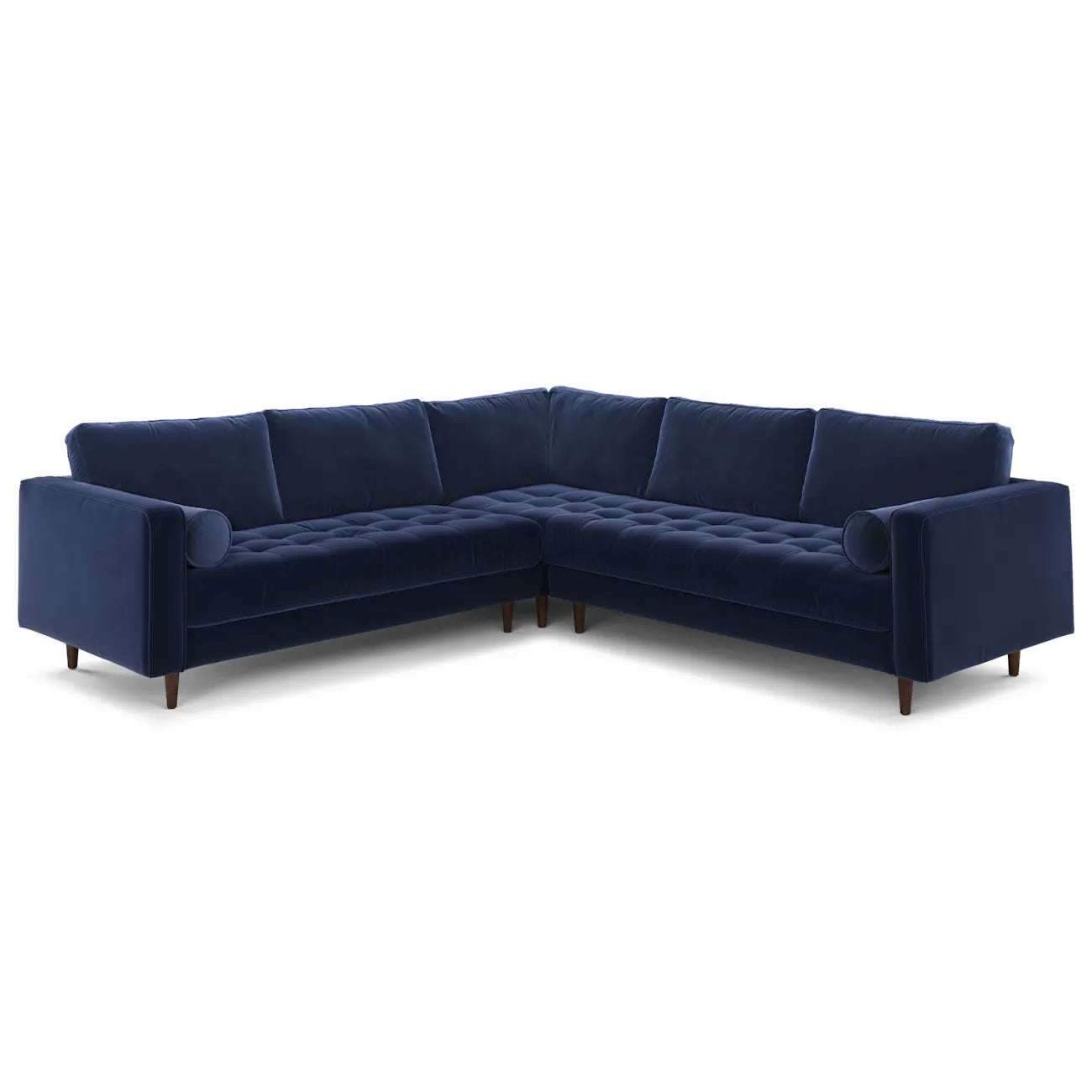 Full front view of the navy velvet corner sectional with tufted bench seat and bolster pillows