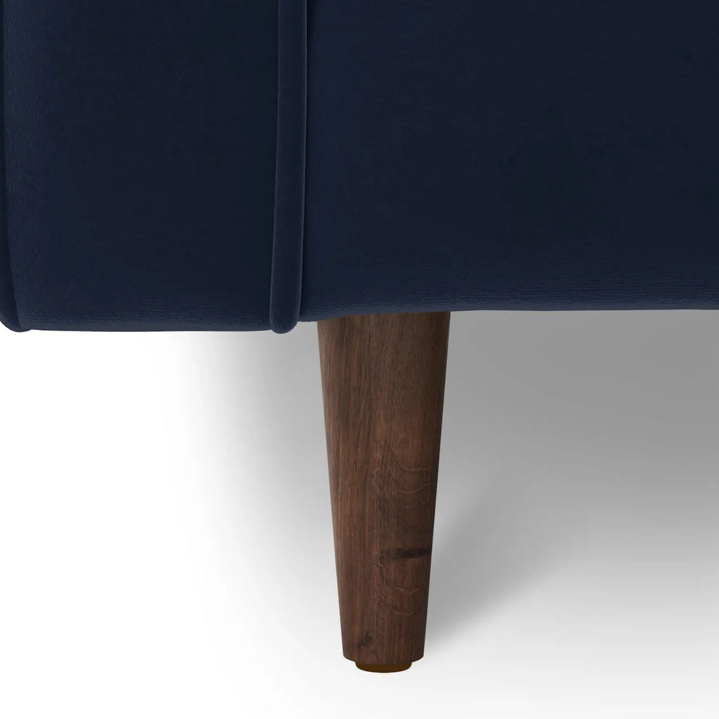 Close-up of the tapered walnut-finished wood leg on the Simone Sectional