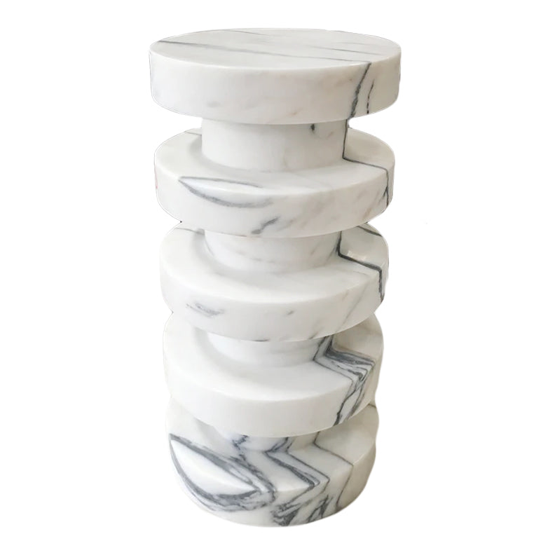 Angled view of stacked marble plinth side table showing sculptural disc silhouette