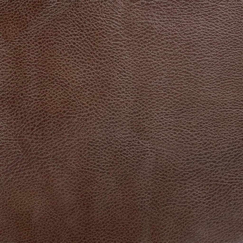 Close-up detail view of the premium tailored upholstery material on the Element storage ottoman, highlighting the rich brown, finely grained textured finish.