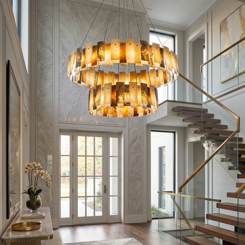 Two-tier alabaster chandelier illuminated above a staircase in a grand entryway