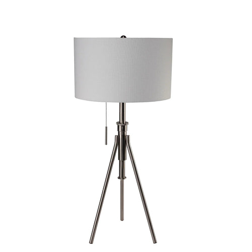 Brushed nickel tripod lamp with neutral fabric drum shade and pull chain on a white background