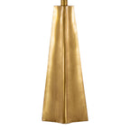Close-up of the faceted gold obelisk base showing its tapered, architectural planes