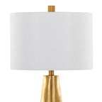 Close-up of the white linen drum shade and brass neck connection on the gold table lamp