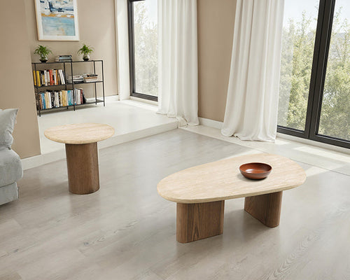 Travertine side table and organic-shaped coffee table with matching oak bases styled together in a living room