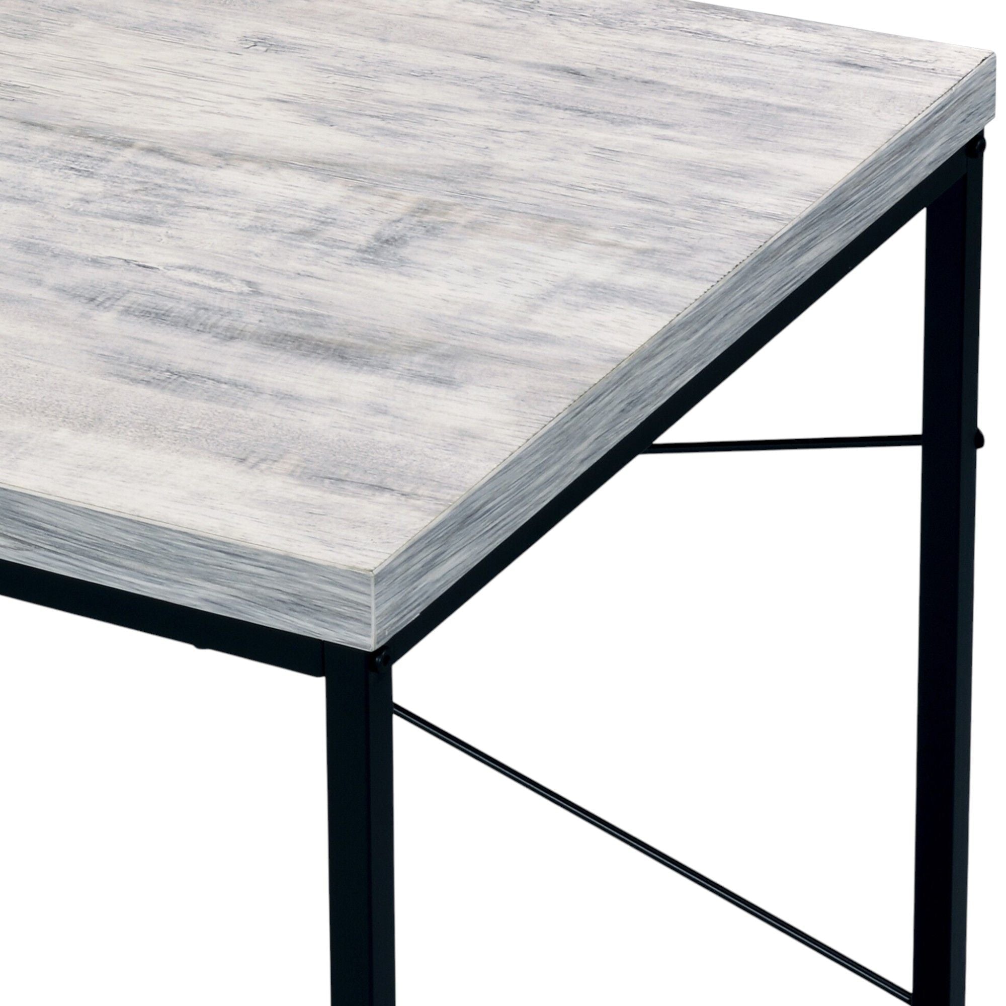 Close-up of the Beau Writing Desk's wood-grain top edge meeting the black iron frame and crossbrace