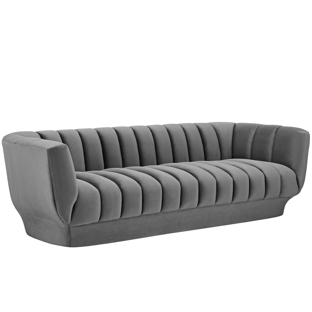 Three-quarter studio profile of the structured charcoal gray velvet Cannelé Sofa against a white background, showcasing its seamless tuxedo frame.