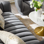 Three-quarter studio profile of the structured charcoal gray velvet Cannelé Sofa against a white background, showcasing its seamless tuxedo frame.