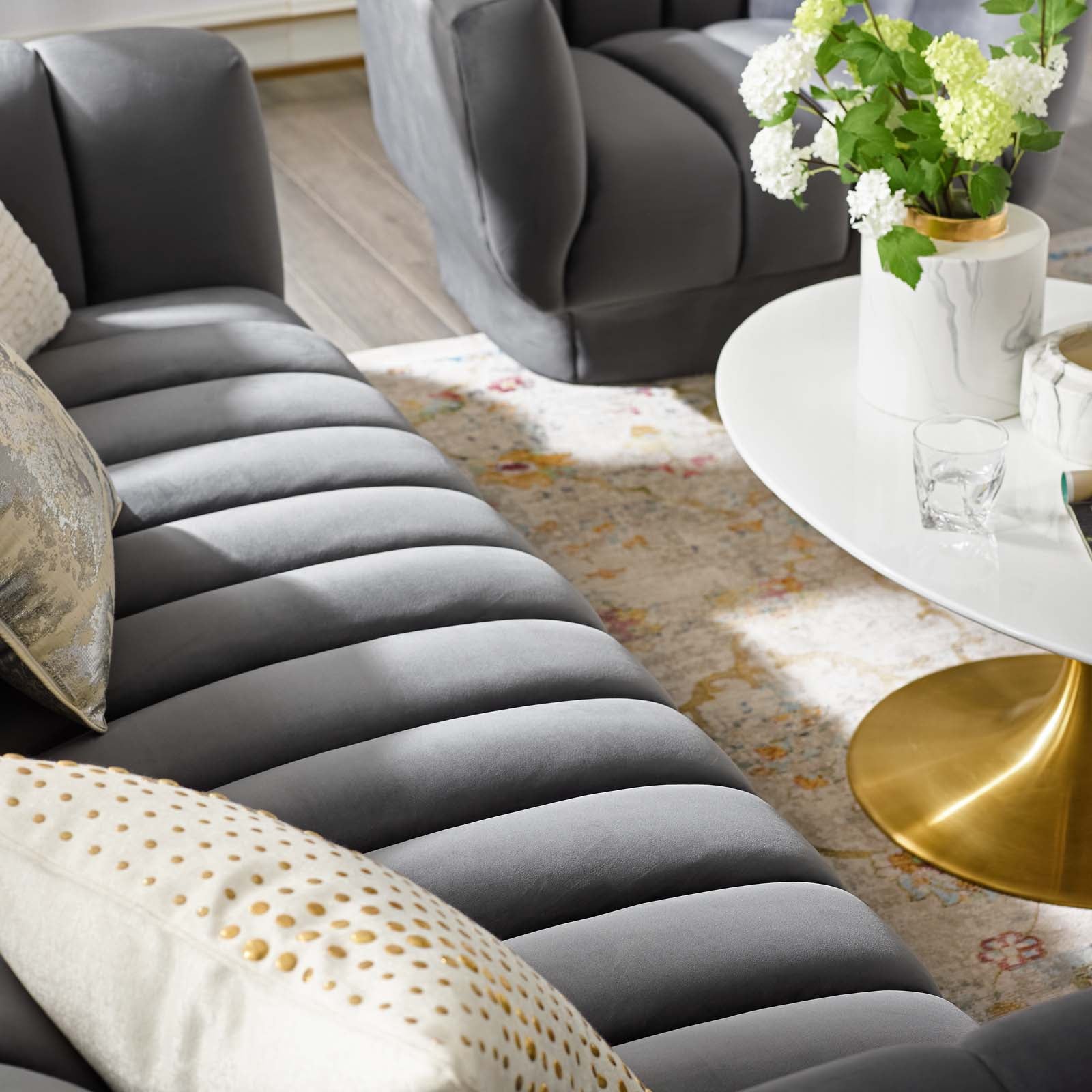 Three-quarter studio profile of the structured charcoal gray velvet Cannelé Sofa against a white background, showcasing its seamless tuxedo frame.