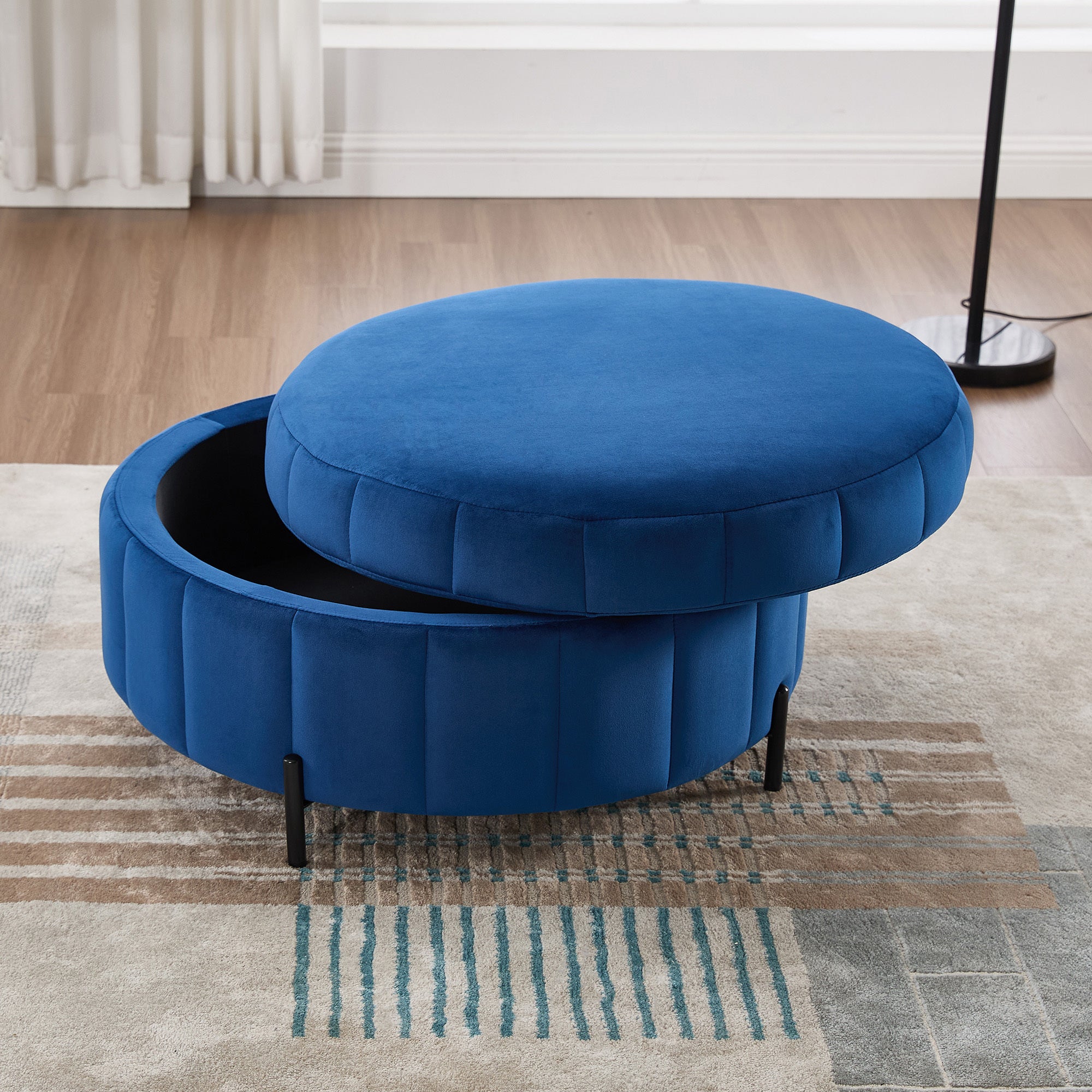 Navy velvet Charlotte Ottoman with reversible lid lifted to reveal the interior storage compartment