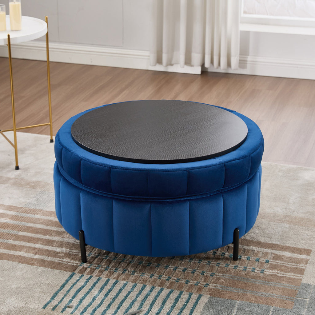 Studio vignette of the navy velvet storage ottoman with the lid inverted to showcase the built-in dark wood tray table surface.