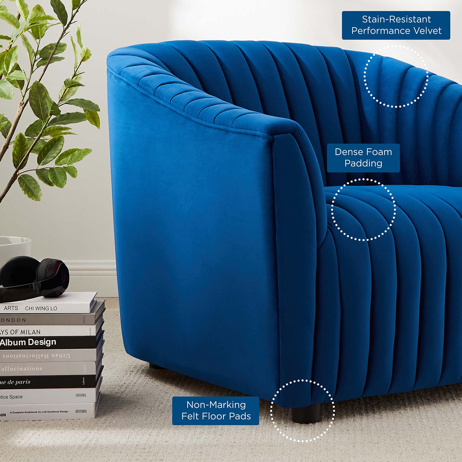 Close-up vignette of the Cobalt Voûte Armchair in navy velvet, highlighting the tight vertical channel tufting, dense padding, and low felt-padded feet.