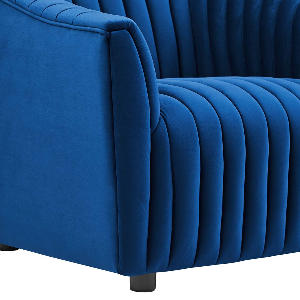 Detailed macro perspective of the crisp, taut vertical channel stitching running continuously down the armrest of the navy velvet armchair.