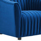 Detailed macro perspective of the crisp, taut vertical channel stitching running continuously down the armrest of the navy velvet armchair.