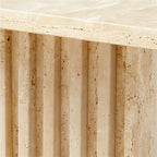 Close-up of the Fontaine Side Table's hand-carved fluted travertine base showing natural stone texture
