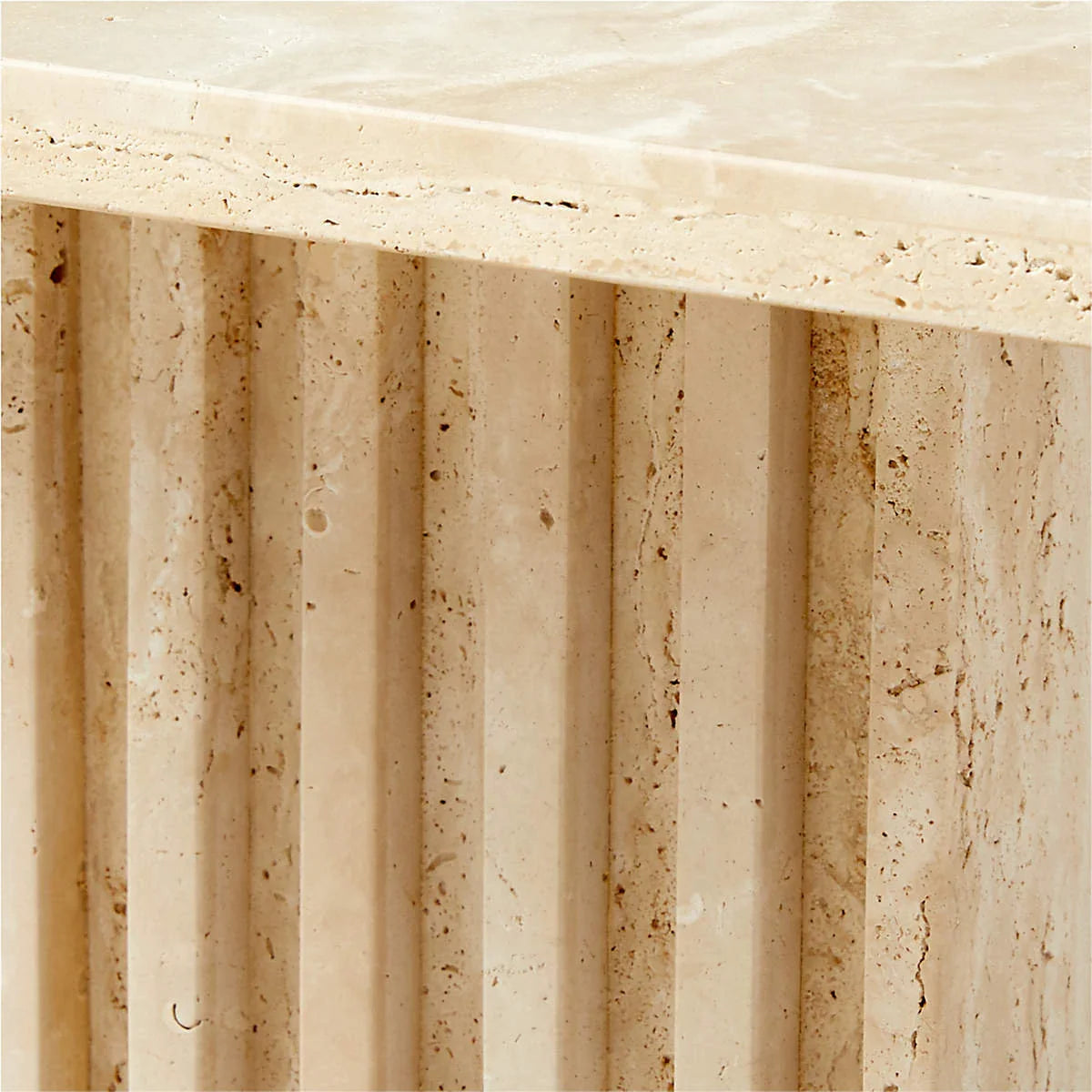 Close-up of the Fontaine Side Table's hand-carved fluted travertine base showing natural stone texture
