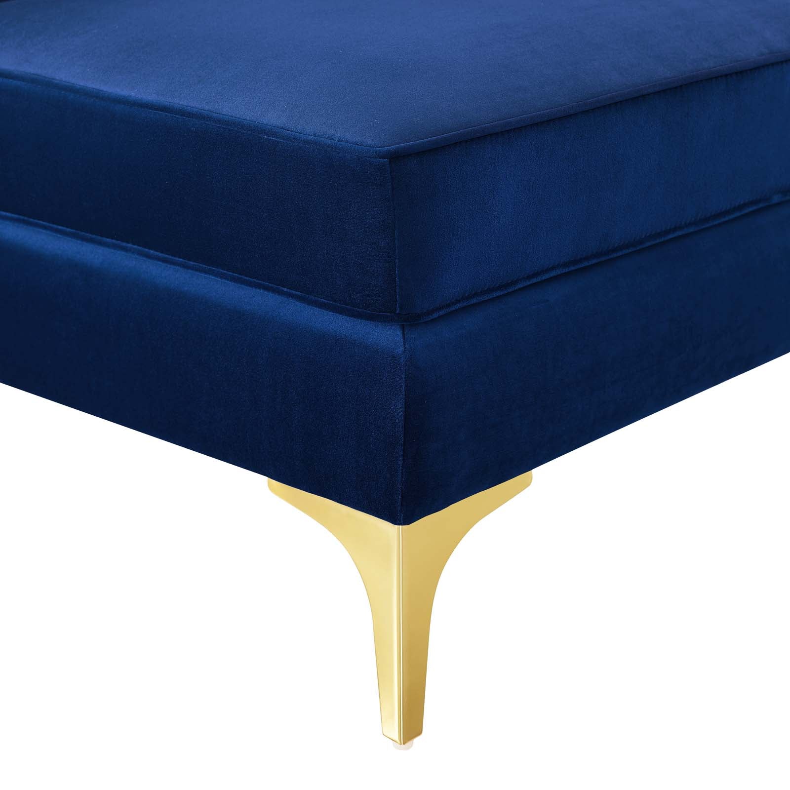 Close-up of the navy velvet cushion corner and gold metal leg detailing