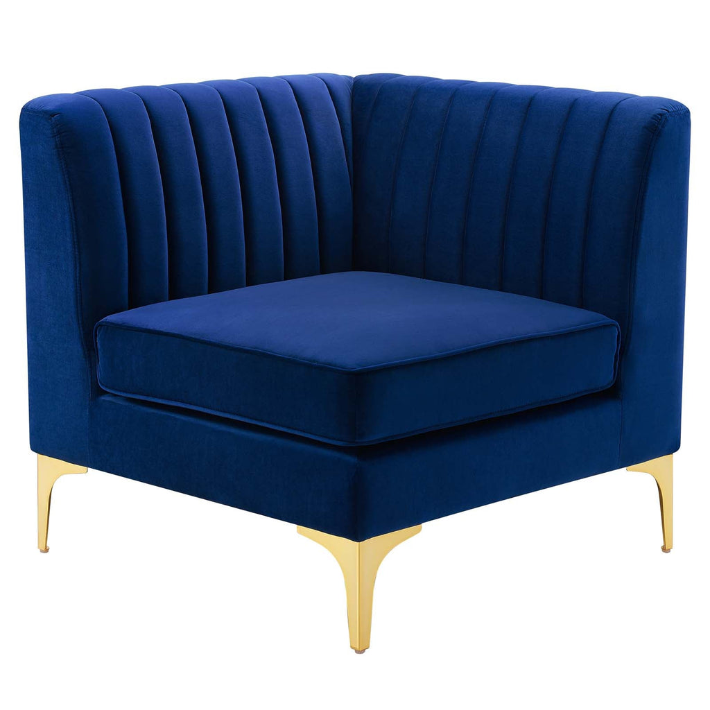 Navy channel-tufted velvet corner chair with gold metal legs, shown against a white background