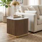 Marble-top reeded end table styled beside a linen sofa with a brass lamp and books