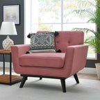 Dusty rose velvet armchair styled beside a window with a patterned accent pillow