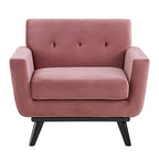 Straight-on front view of the Camille Armchair showing tufted backrest and black wood legs