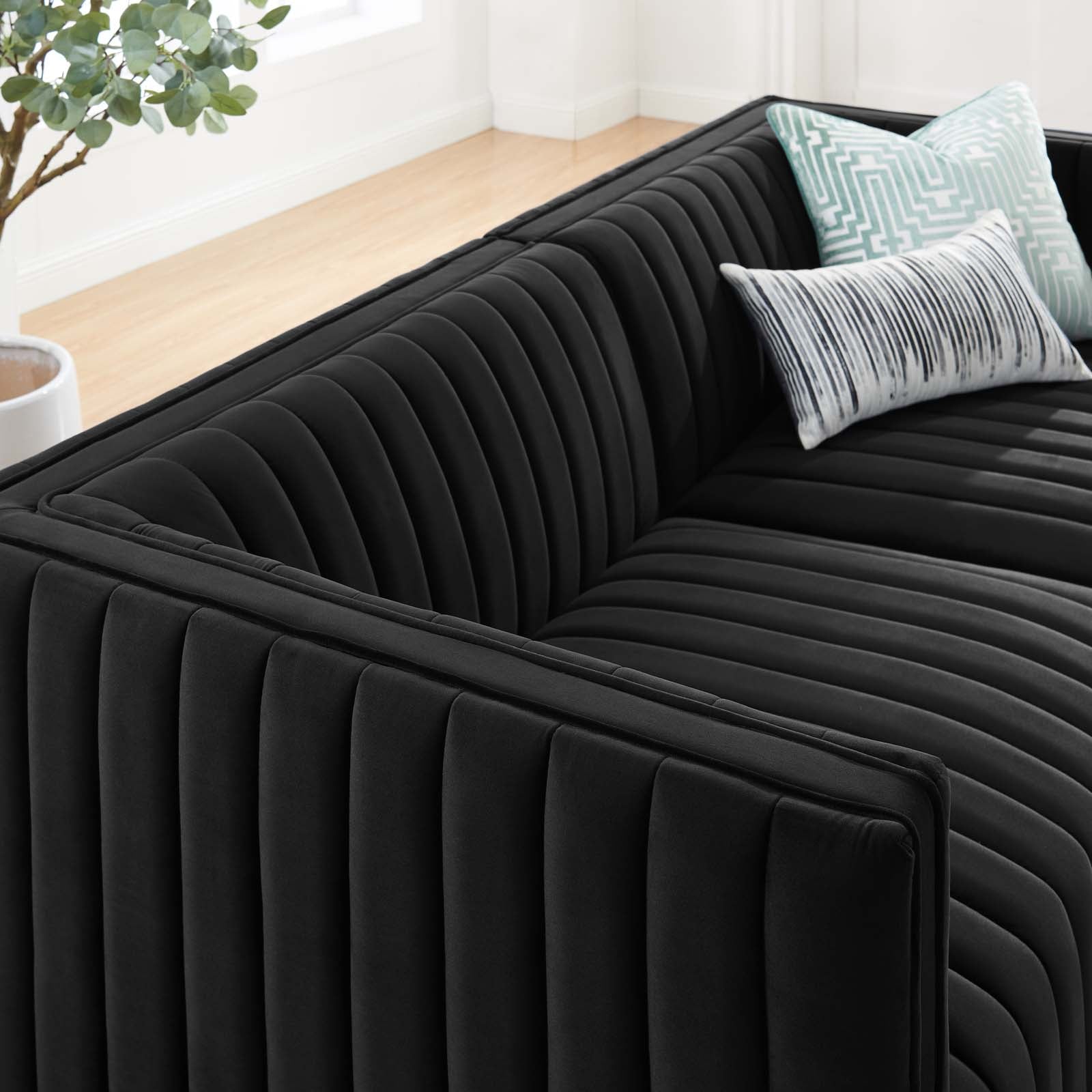 Close-up of continuous vertical channel tufting on the Marceau Loveseat with patterned throw pillows