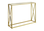 Gold metal console table with crossed X-frame base and glass top, shown against a white background