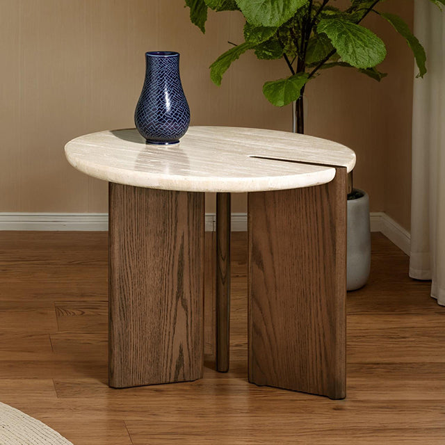 Round travertine side table with notched ash tripod base styled beside a potted plant