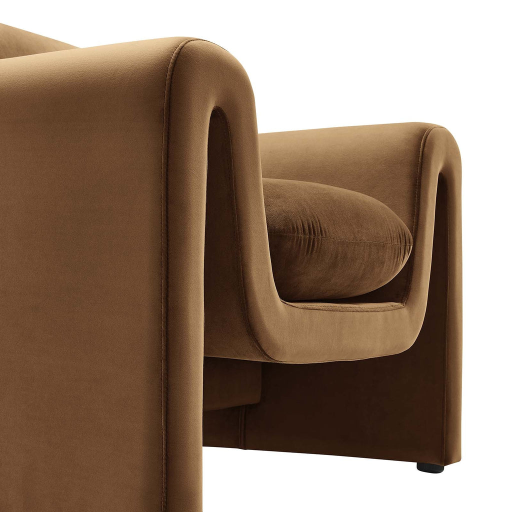 Close-up of the Odile Armchair's removable seat cushion and curved velvet armrest