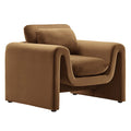  Cognac velvet armchair with continuous curved arms on a white background