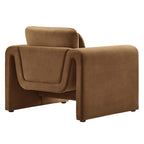 Rear three-quarter view of the cognac velvet Odile Armchair showing its continuous curved frame