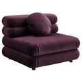 Deep plum velvet armless chair with stacked, rounded cushions and a round bolster pillow, shown against a white background