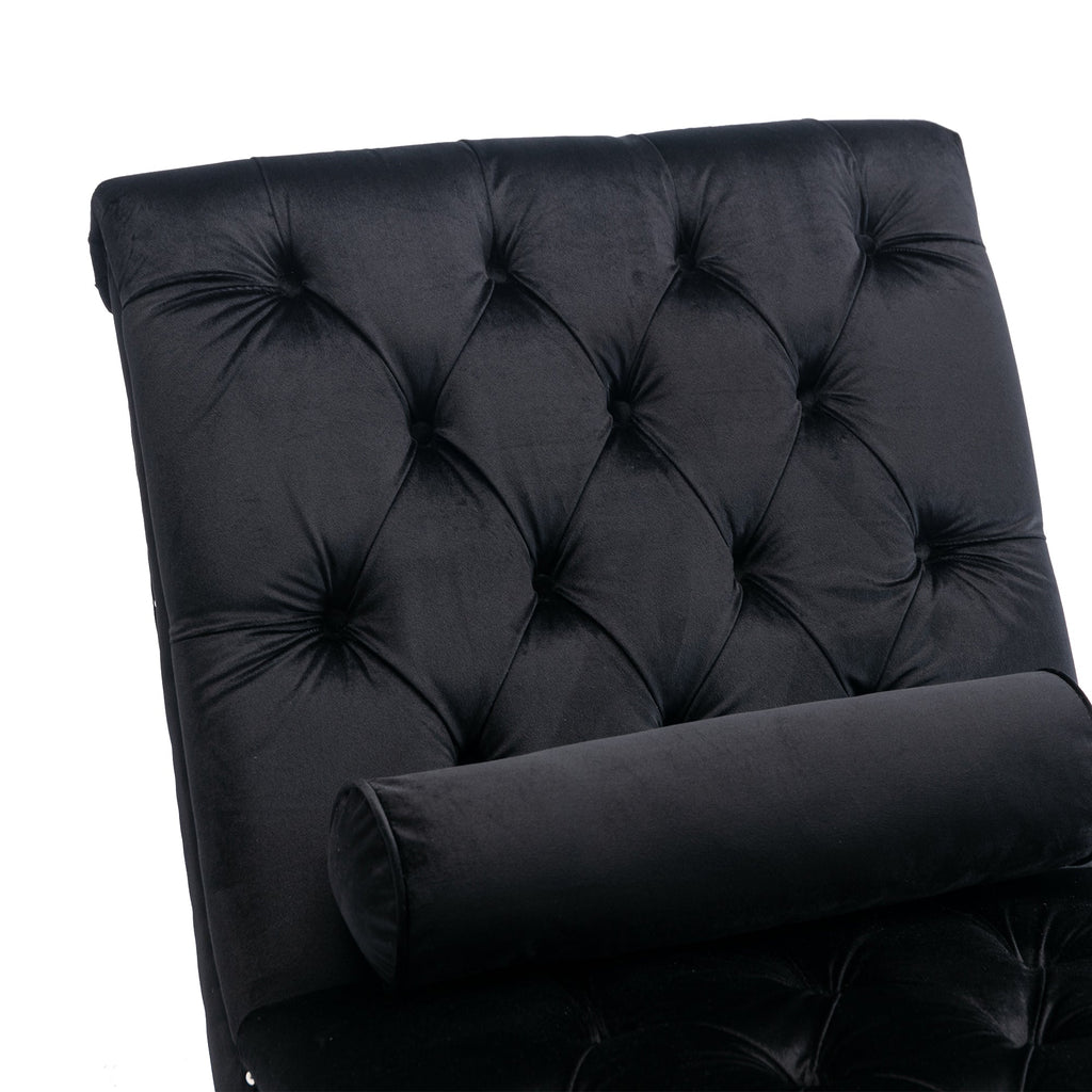 Close-up of deep diamond button-tufted black velvet with a bolster pillow on the Rochelle Chaise