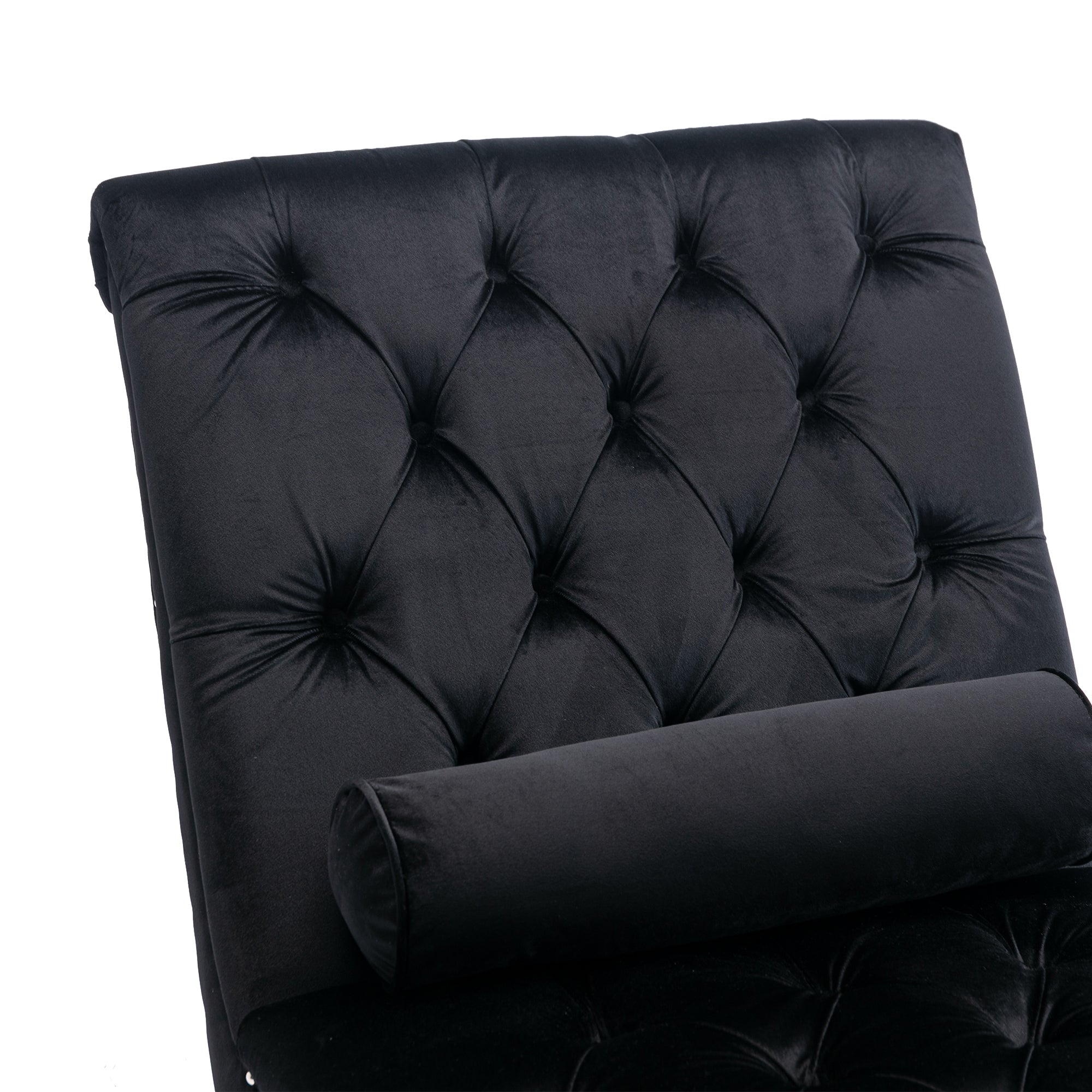 Close-up of deep diamond button-tufted black velvet with a bolster pillow on the Rochelle Chaise