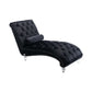 Black velvet S-curve chaise lounge with nailhead trim and acrylic feet on a white background