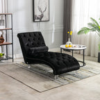 Black velvet Rochelle chaise lounge with acrylic feet styled in a neutral living room beside a marble side table