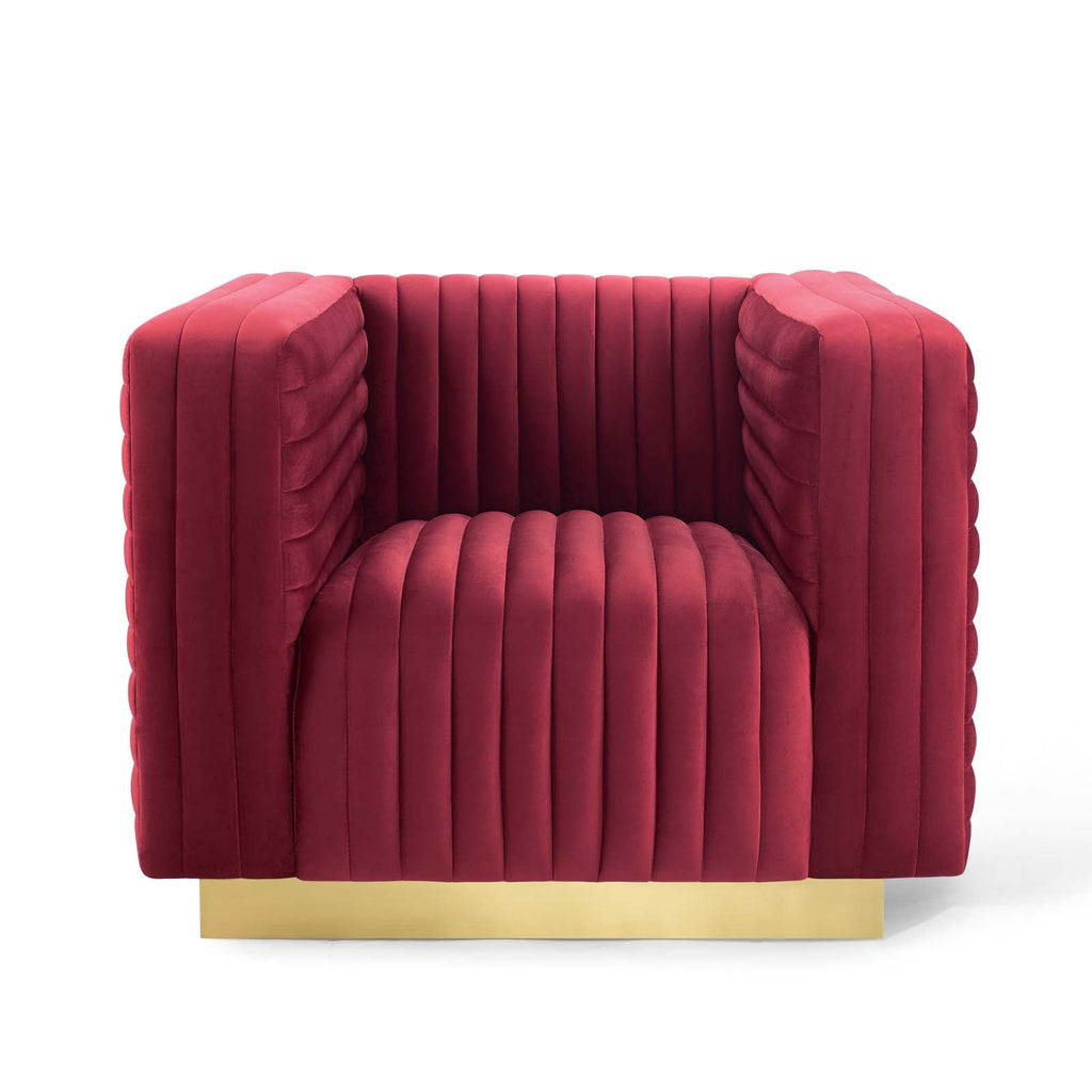 Symmetrical front orthographic view of the architectural maroon velvet Rubis Bloc Armchair showcasing its crisp tuxedo frame and recessed gold base.