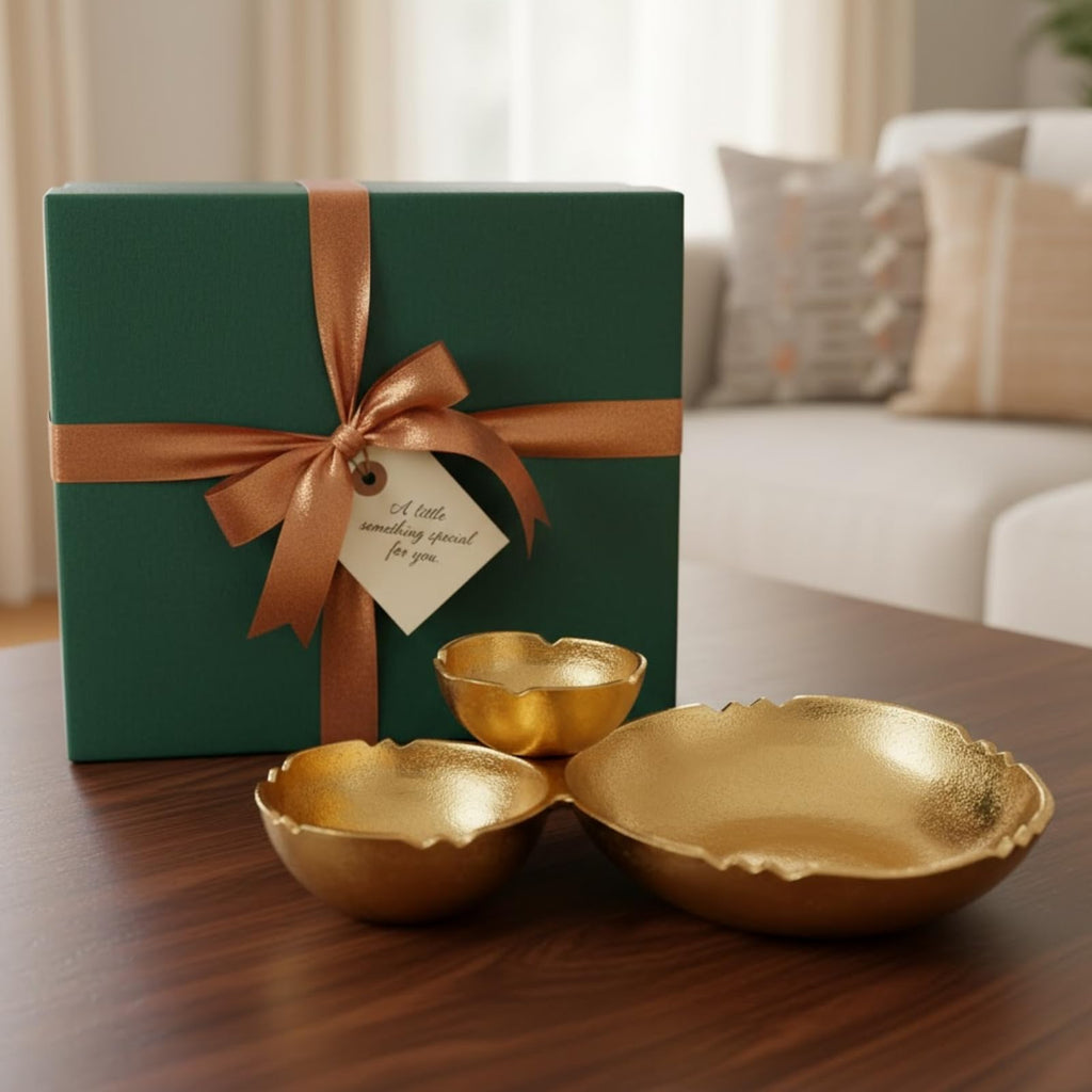 Gold aluminum bowl trio displayed beside a wrapped gift box with a copper ribbon and gift tag