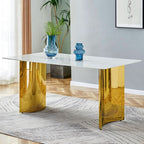 White marble glass-veined dining table with sculptural gold column base, styled with blue glass vases