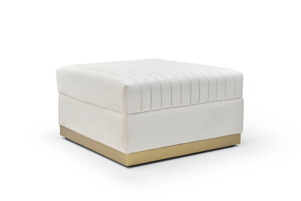 Ivory velvet channel-tufted ottoman with brushed gold plinth base on a white background