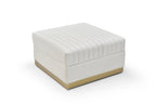 Ivory velvet channel-tufted ottoman with brushed gold base shown from a high angle on a white background