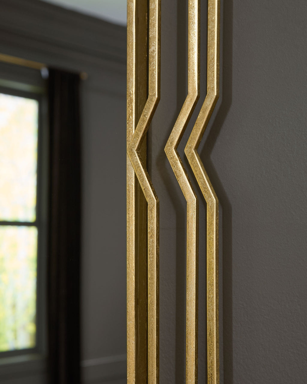 Close-up of the gold foil frame's layered chevron edge detailing