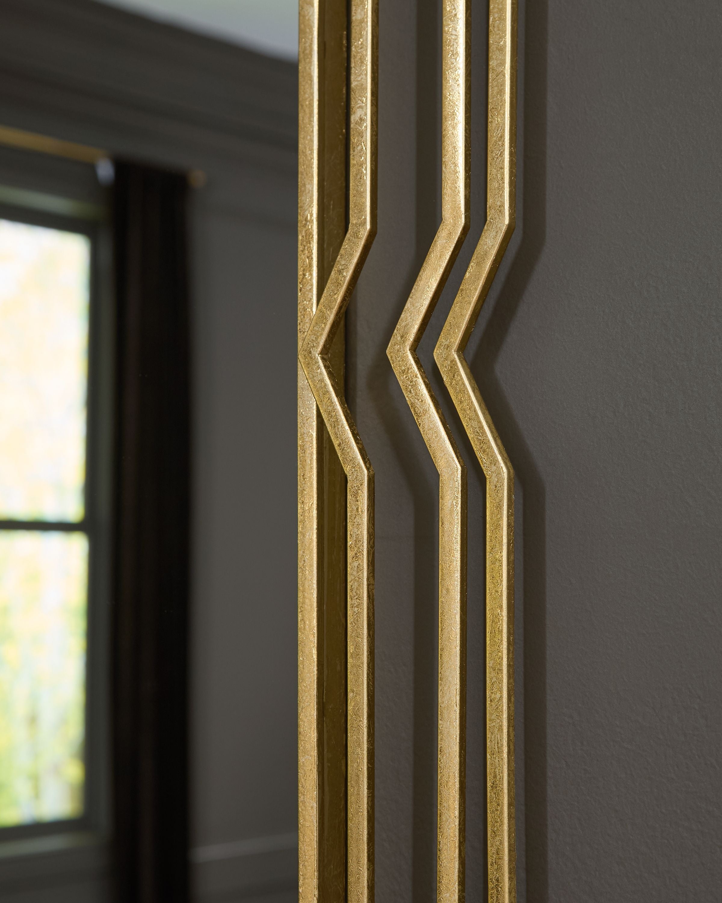 Close-up of the gold foil frame's layered chevron edge detailing