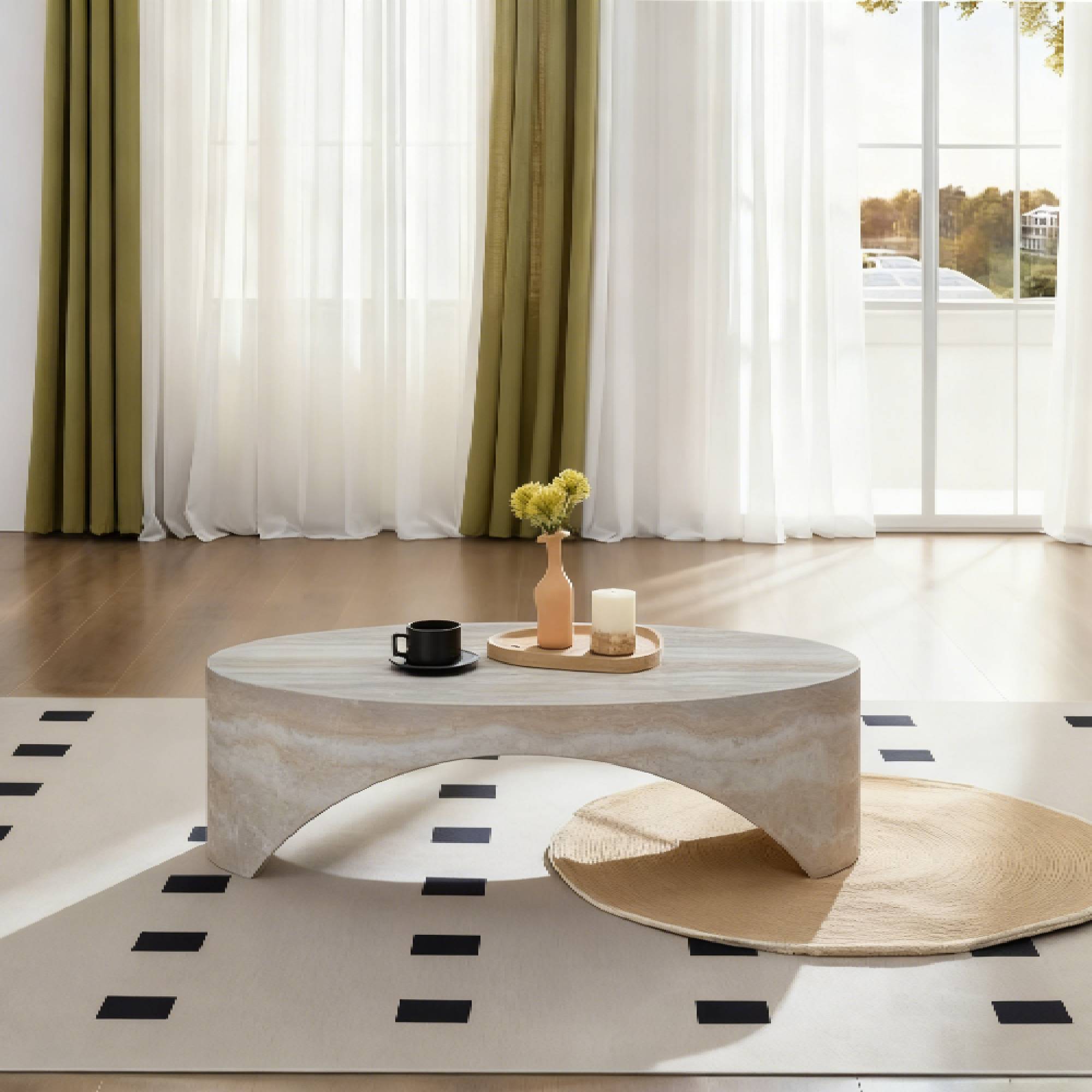 Symmetrical front elevation view of the low-profile Voûte Coffee Table in a modern living room showcasing the clean negative space under its structural arch.