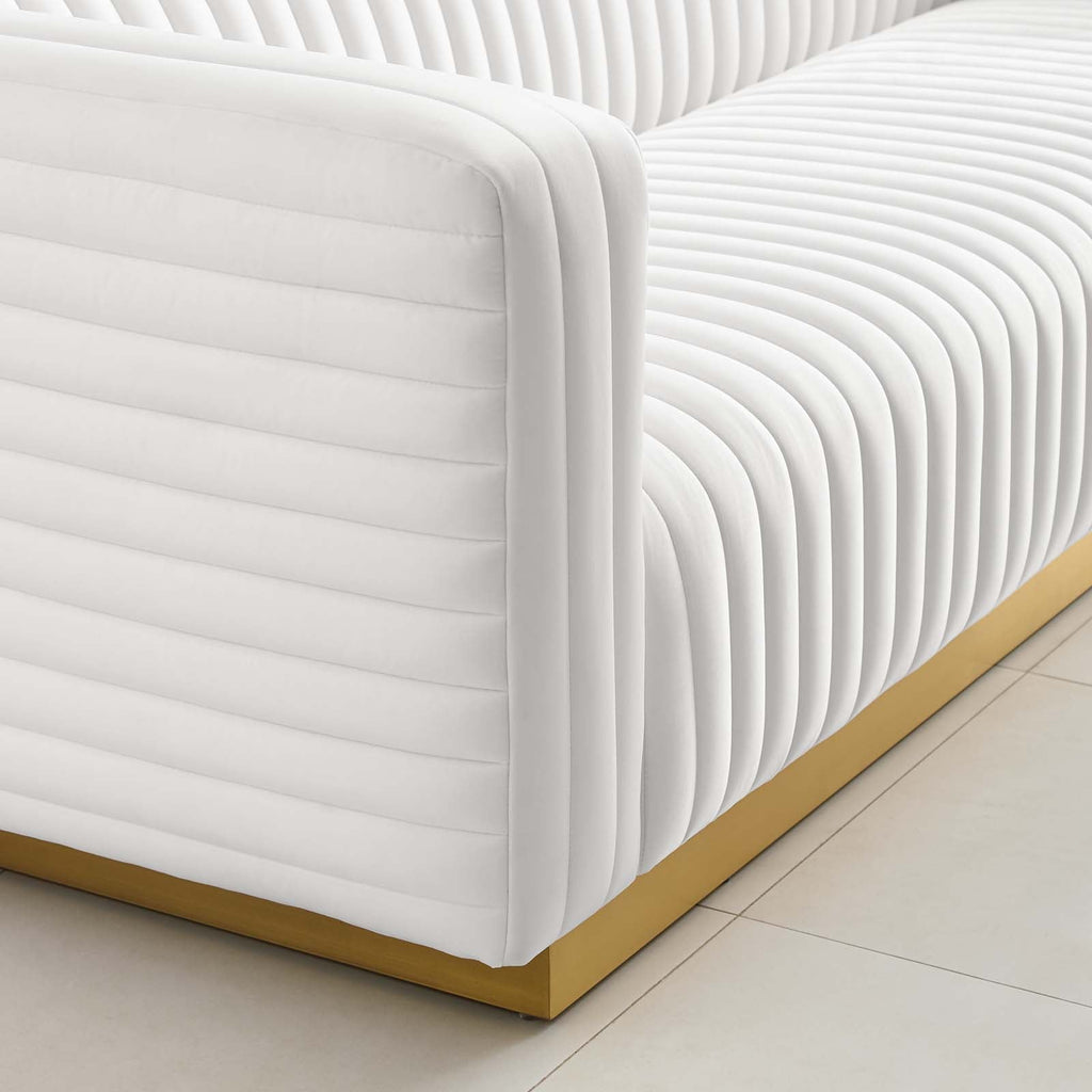 Close-up of continuous channel tufting wrapping the arm and base of the Éloise Sofa in ivory velvet