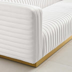 Close-up of continuous channel tufting wrapping the arm and base of the Éloise Sofa in ivory velvet