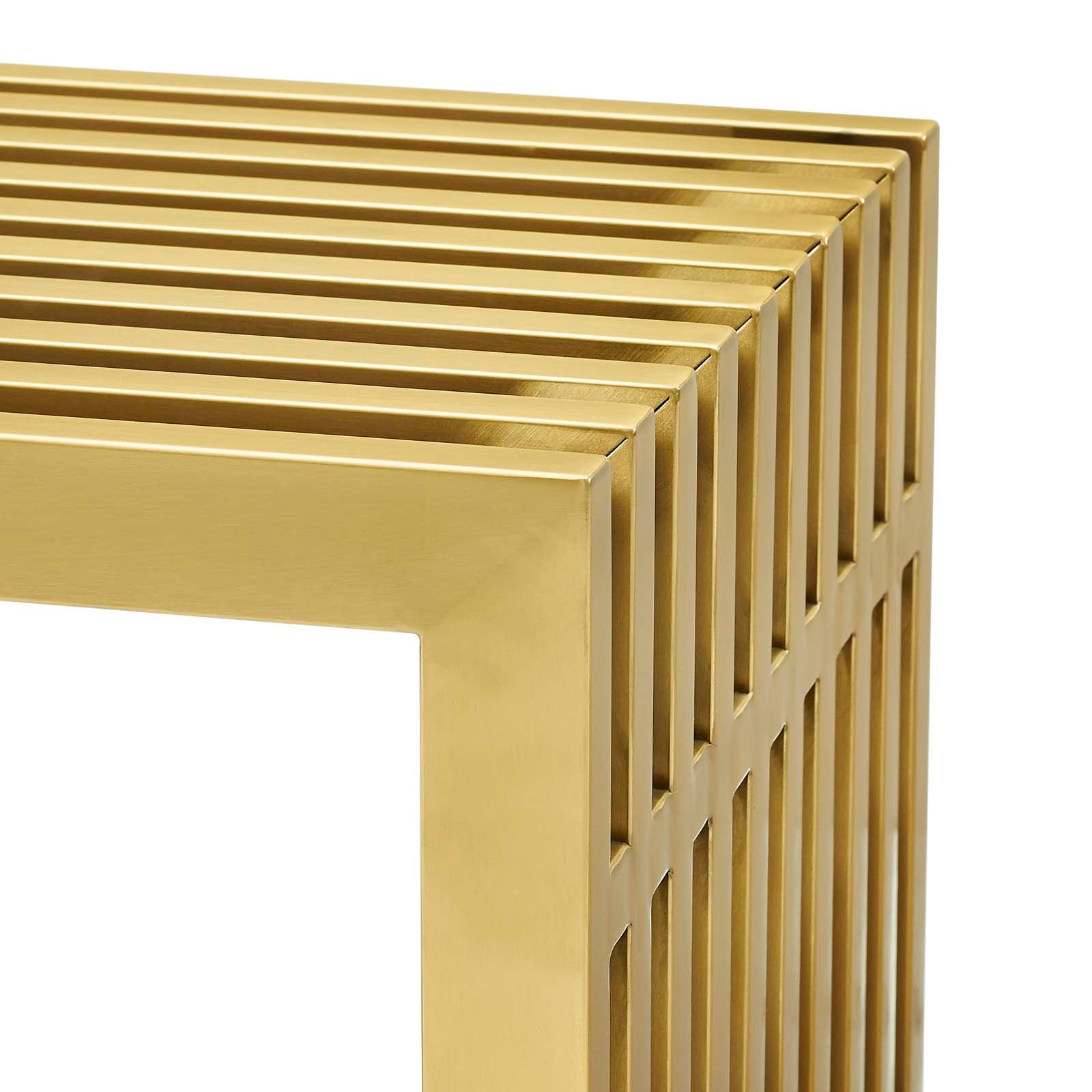 Close-up of gold steel console table corner showing stacked square tube rail construction