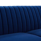 Close-up of vertical channel tufting detail on the Winsome Sofa's navy velvet backrest