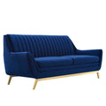 Navy channel-tufted velvet sofa with flared arms and brushed gold legs, shown at a front angle